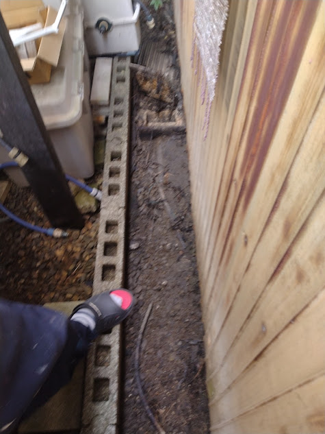 この屋外にある、一番奥にあるキッチンの排水桝から先(手前方向)が傾斜になっている。これにより、つまりが発生すると逆流して隣家んぽ敷地含めた屋外にあふれ出す事態になっていた